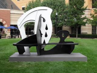 Abstract metal sculpture, painted half white, half black.